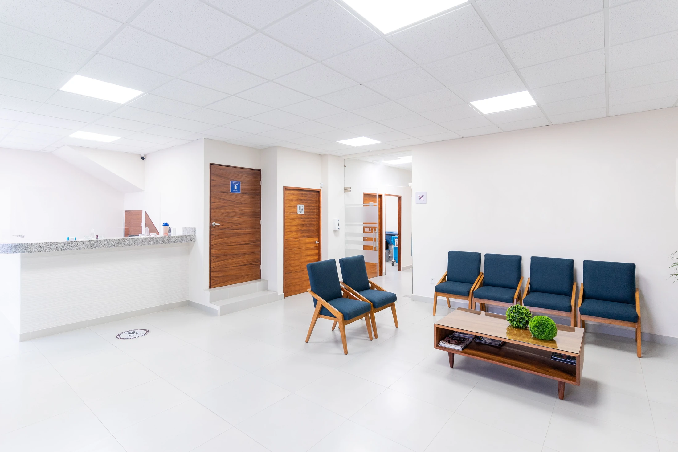 A bright healthcare waiting area with reception and seating