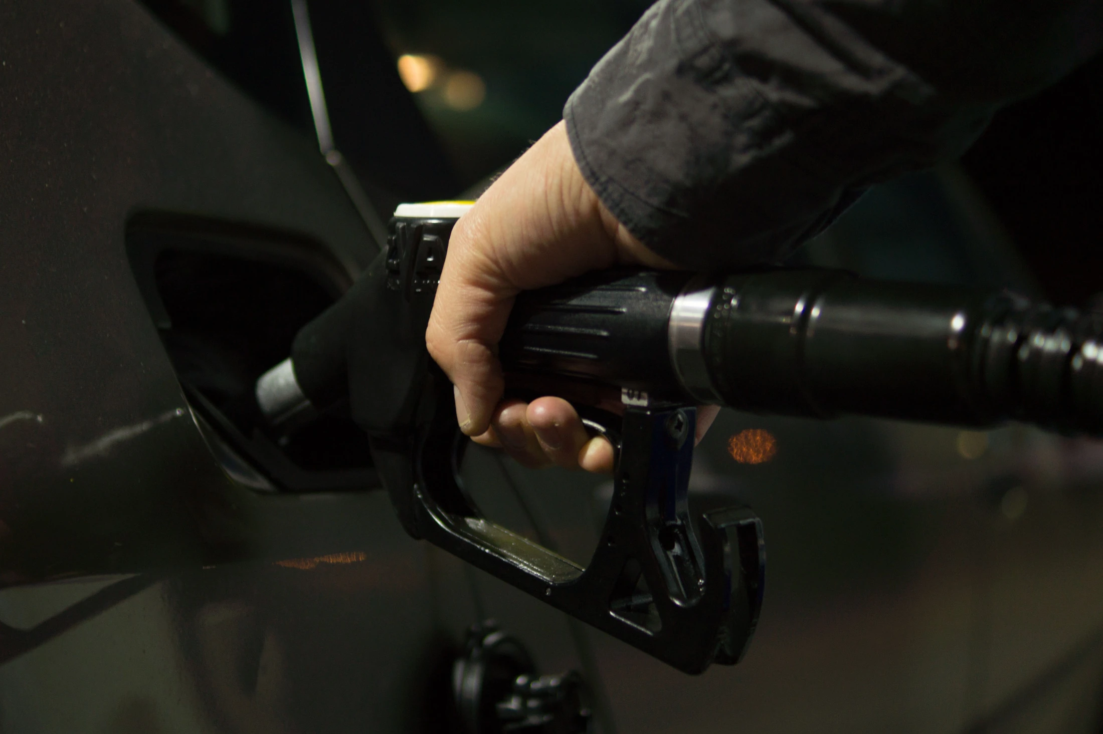 A driver refuelling a vehicle at a service station
